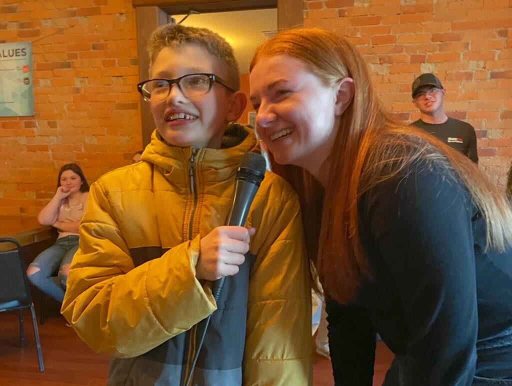 Two students smiling together indoors