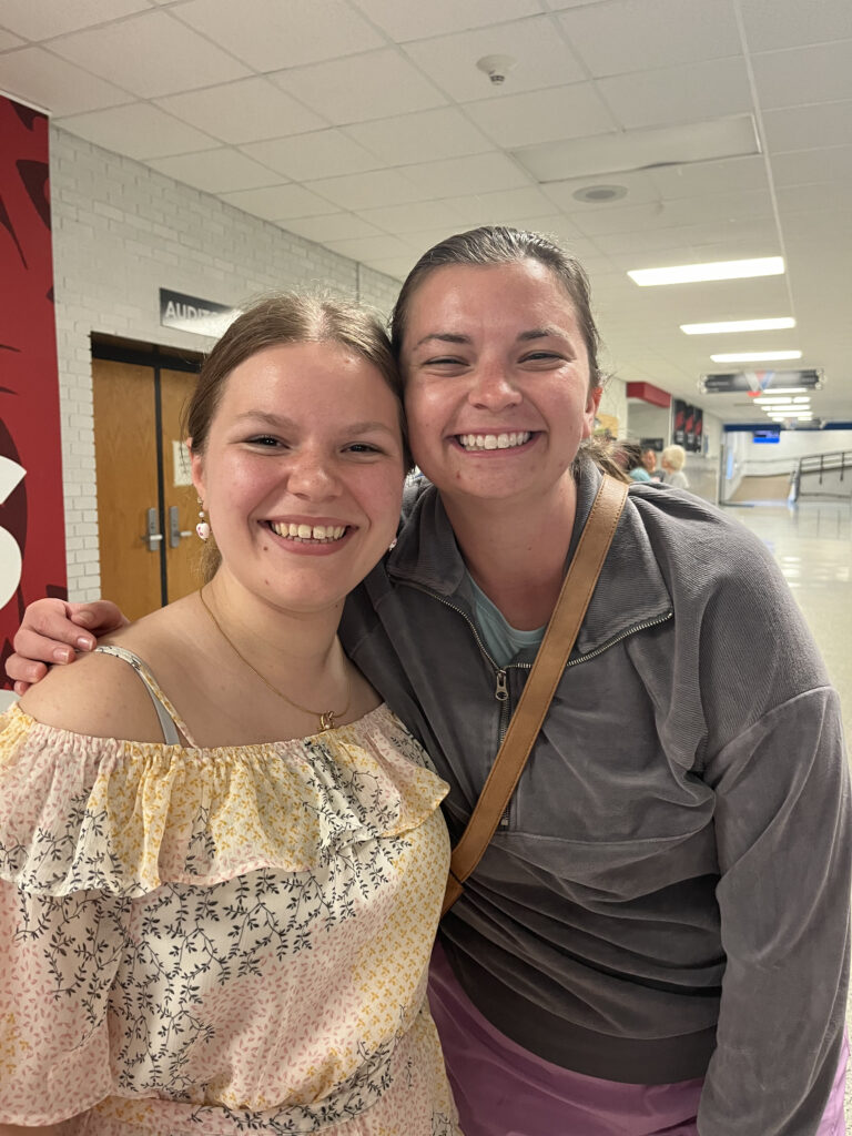 Two women smiling together indoors