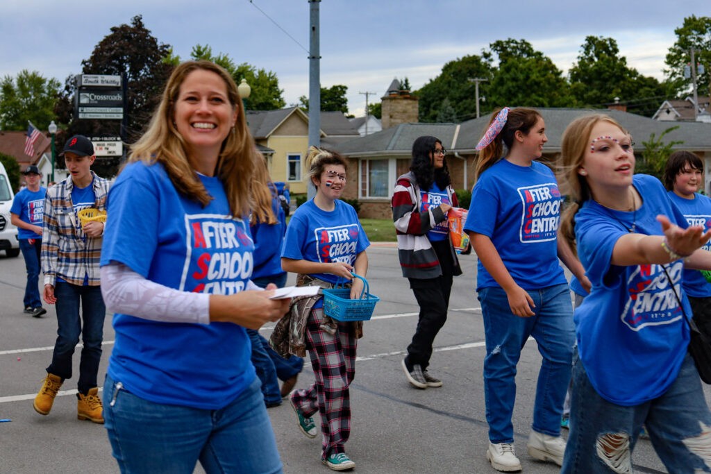 Students and leaders in matching blue shirts outdoors