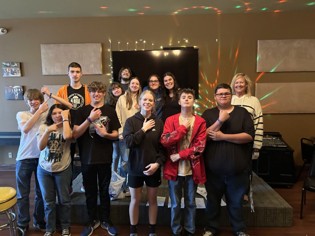 A large group of students posing together in a room