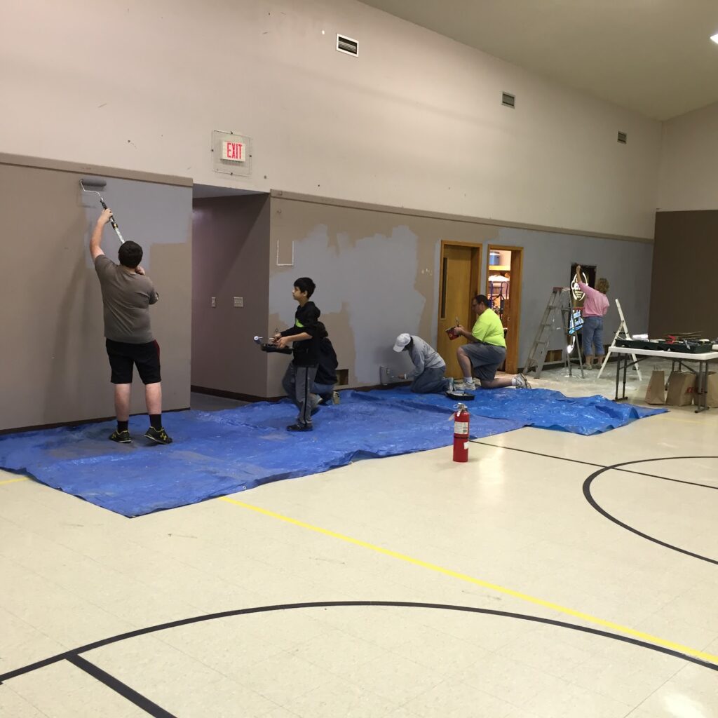 Volunteers painting during the building renovation