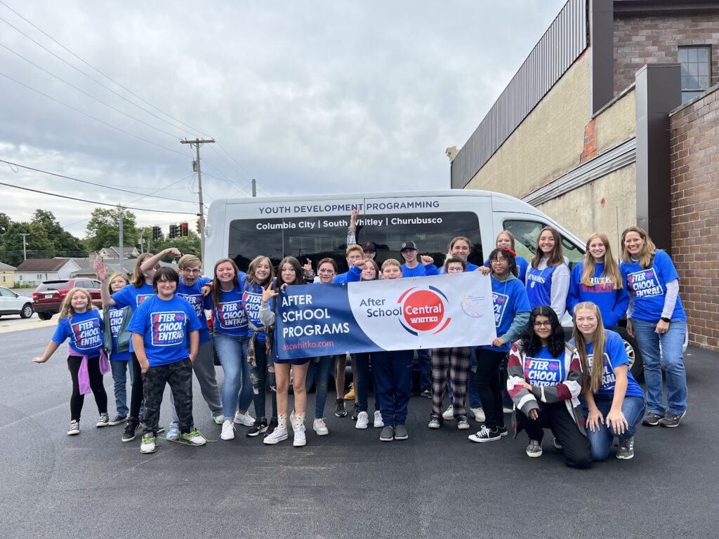 Whitko After-School Central students holding a program banner